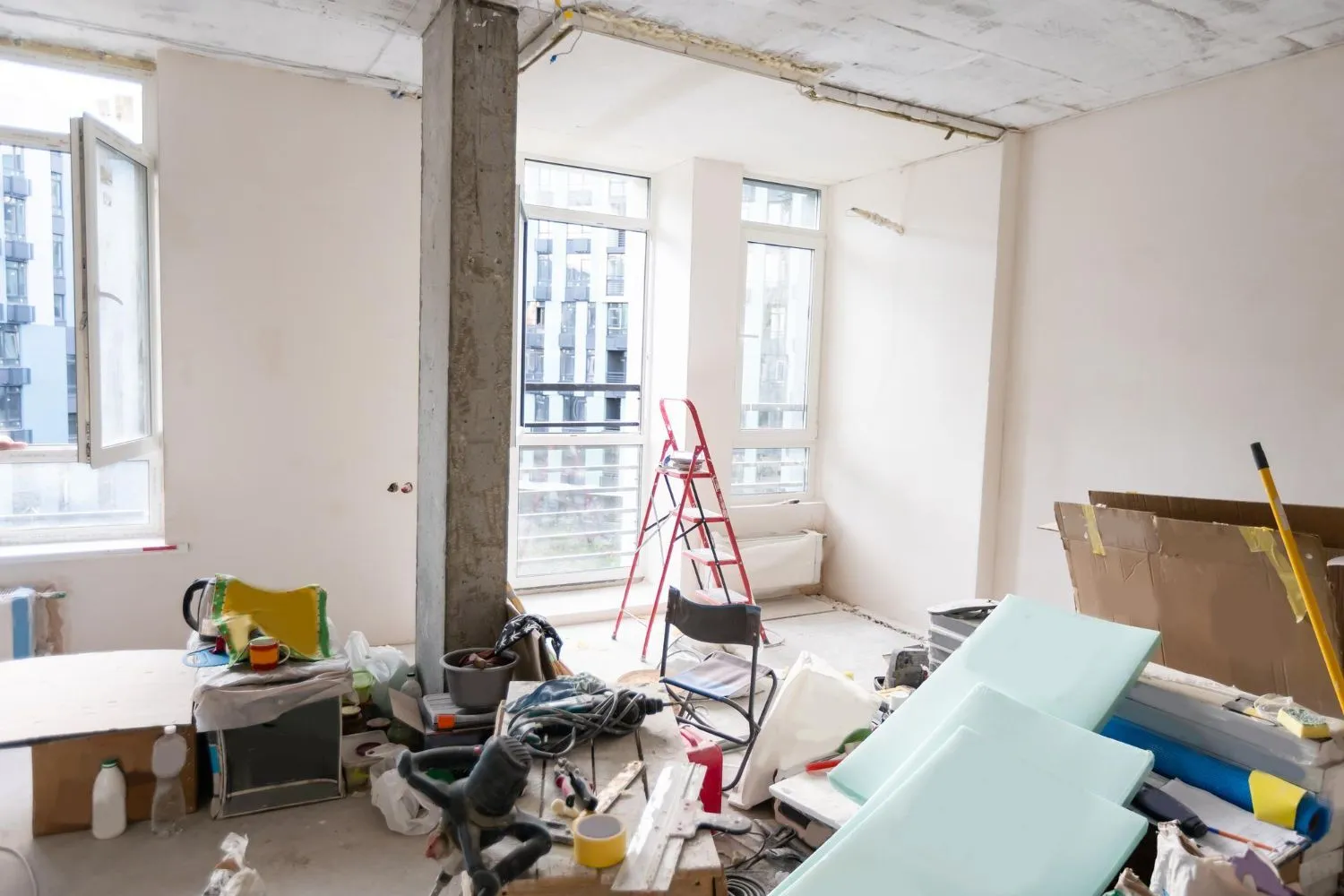 Room under reconstruction with building materials and a ladder